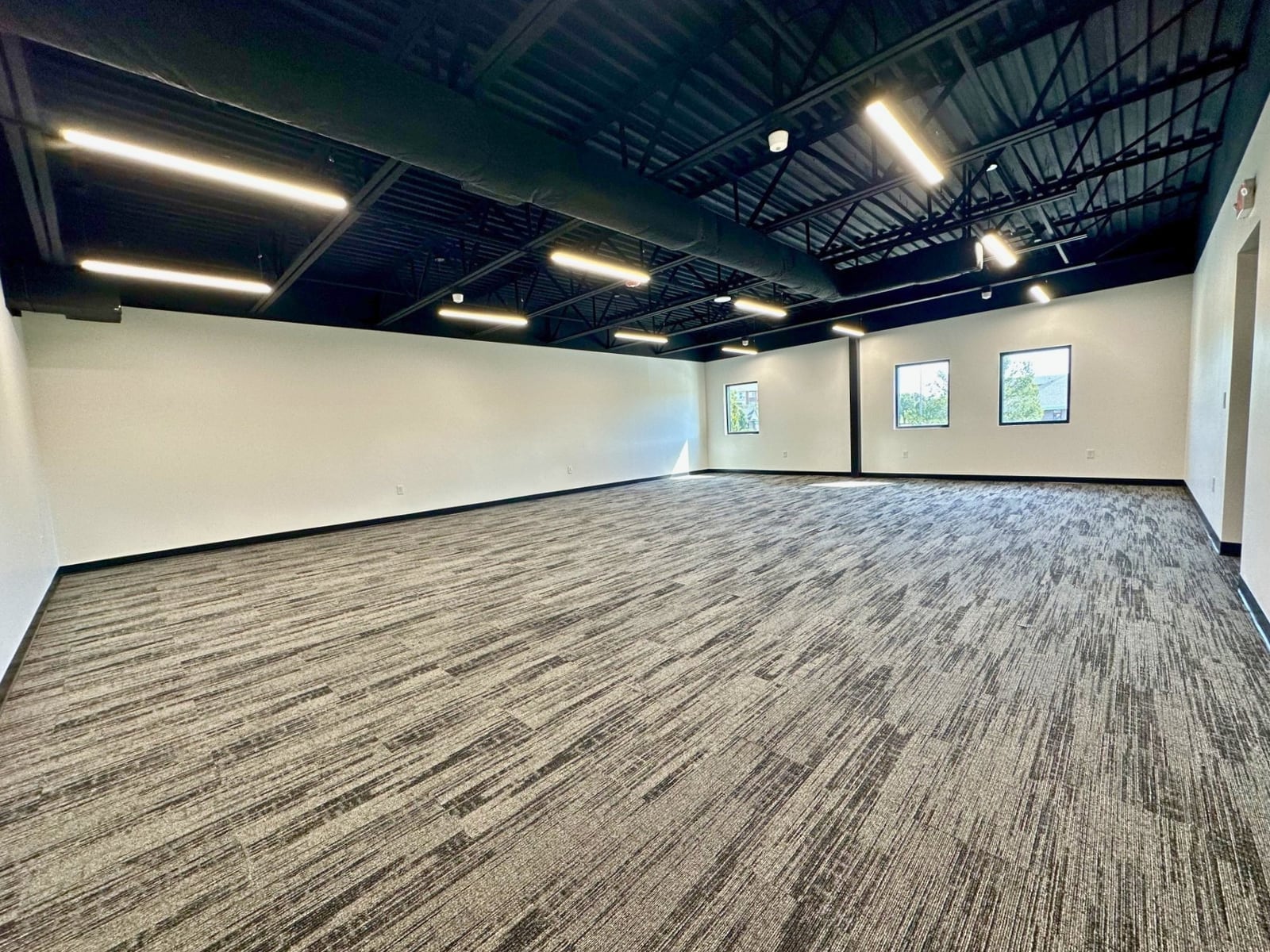 An open mezzanine floor with exposed ceiling and windows at SpringPad in Lincoln, Nebraska