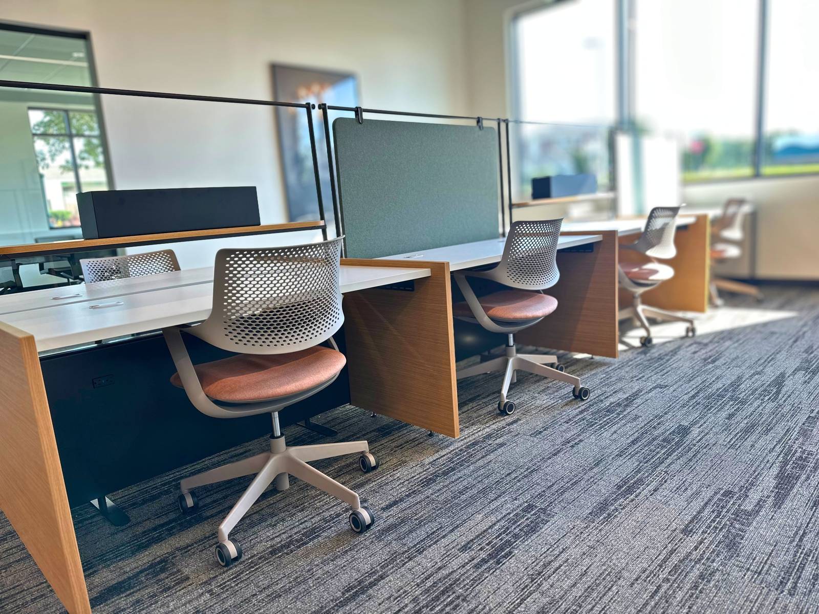 Bright hoteling desk row beside the windows at SpringPad in Lincoln, Nebraska