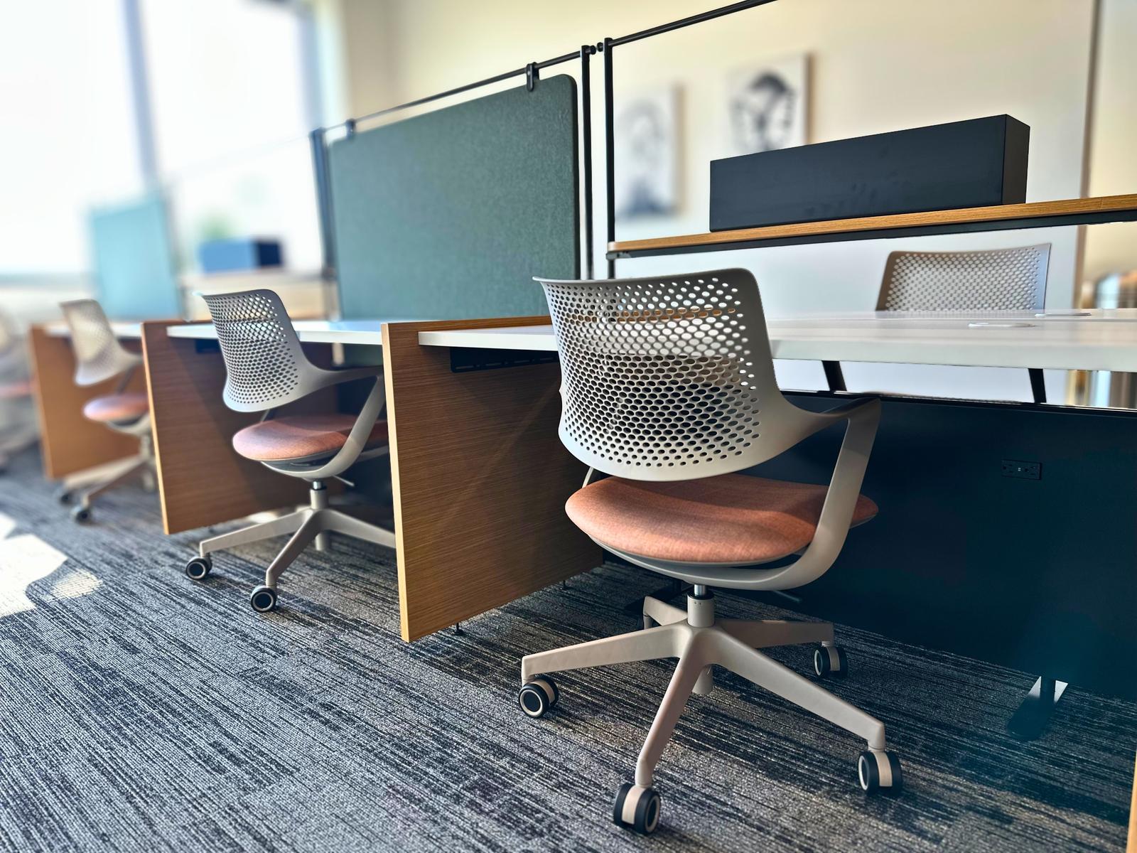 Hoteling desks in warm afternoon light at SpringPad in Lincoln, Nebraska