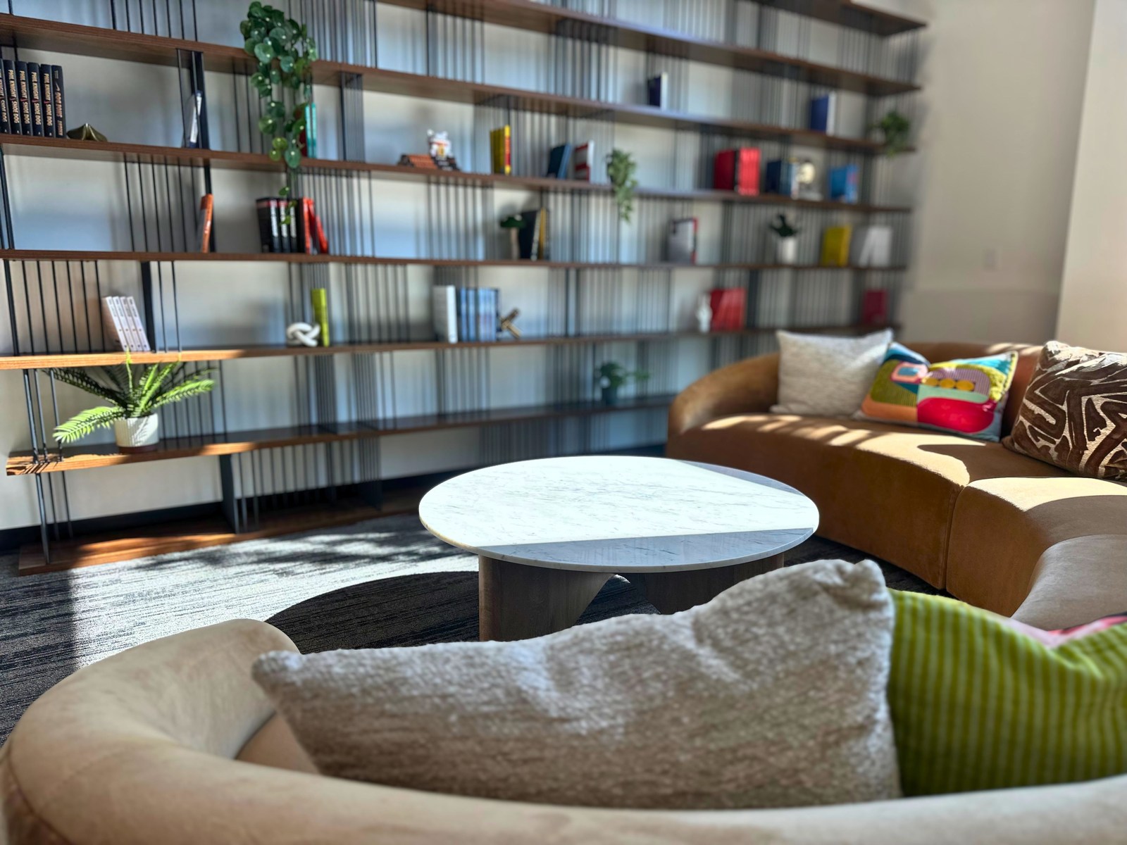 Lounge seating and marble coffee table by the library shelves at SpringPad in Lincoln, Nebraska