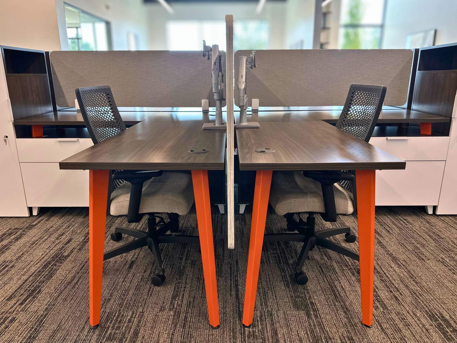 Paired desks with monitor arms and lockable storage at SpringPad in Lincoln, Nebraska