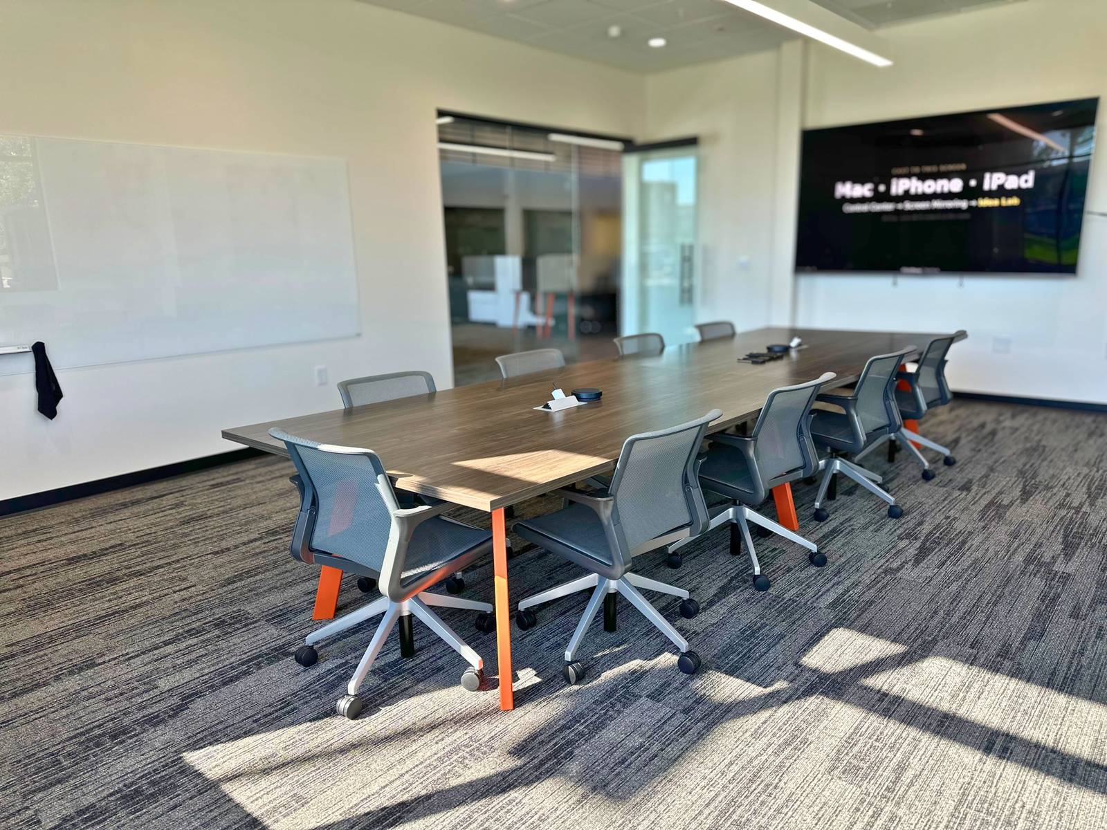 Wide view of a private meeting room with a long table at SpringPad in Lincoln, Nebraska