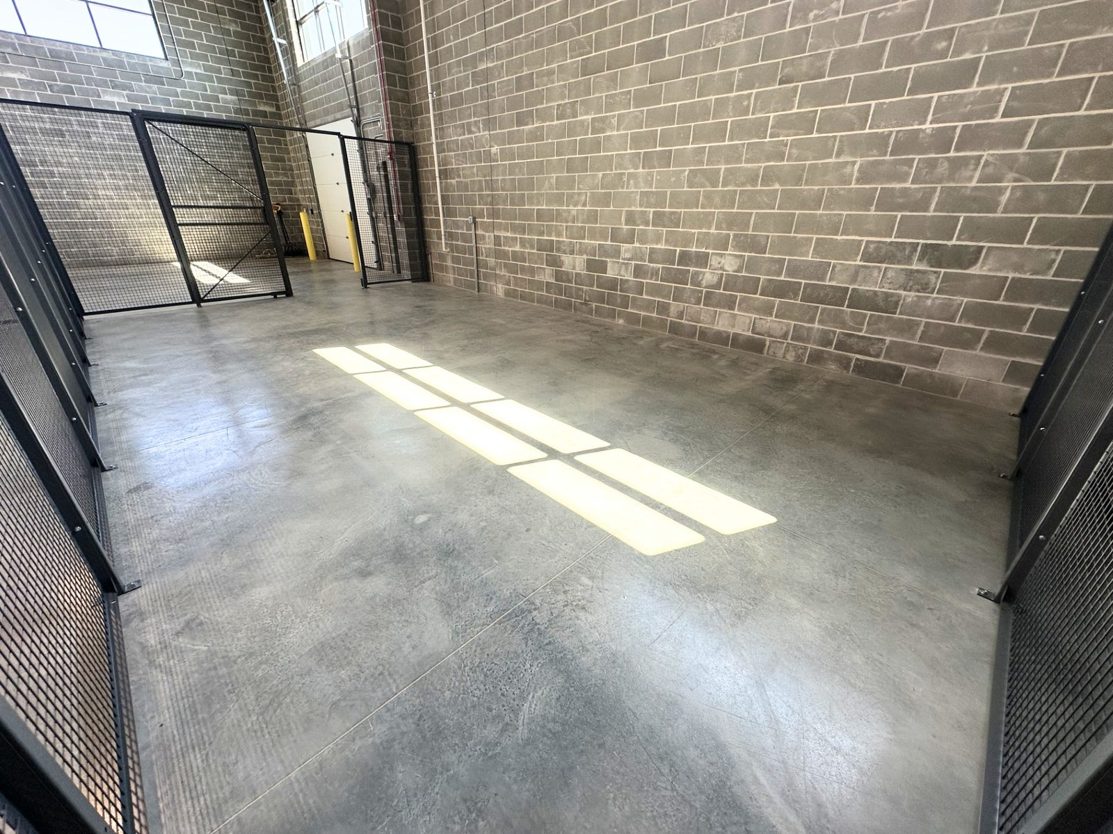 A second view of a fenced warehouse bay at SpringPad in Lincoln, Nebraska